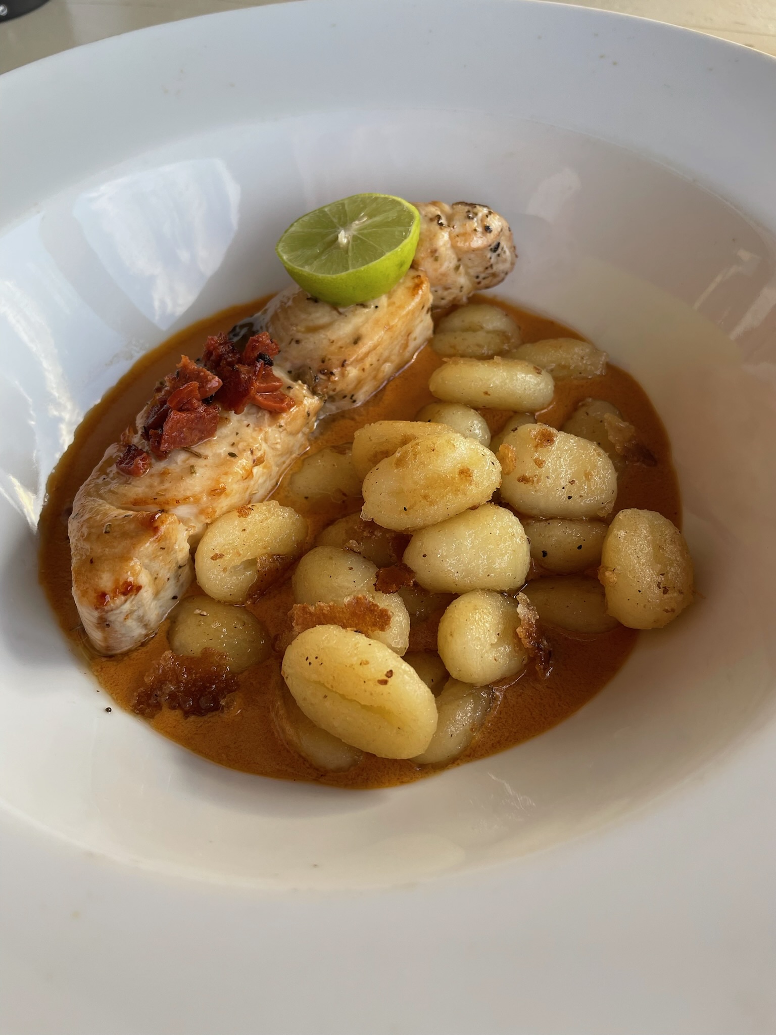 Fish with gnocchi in sauce at Moorea Beach Cafe