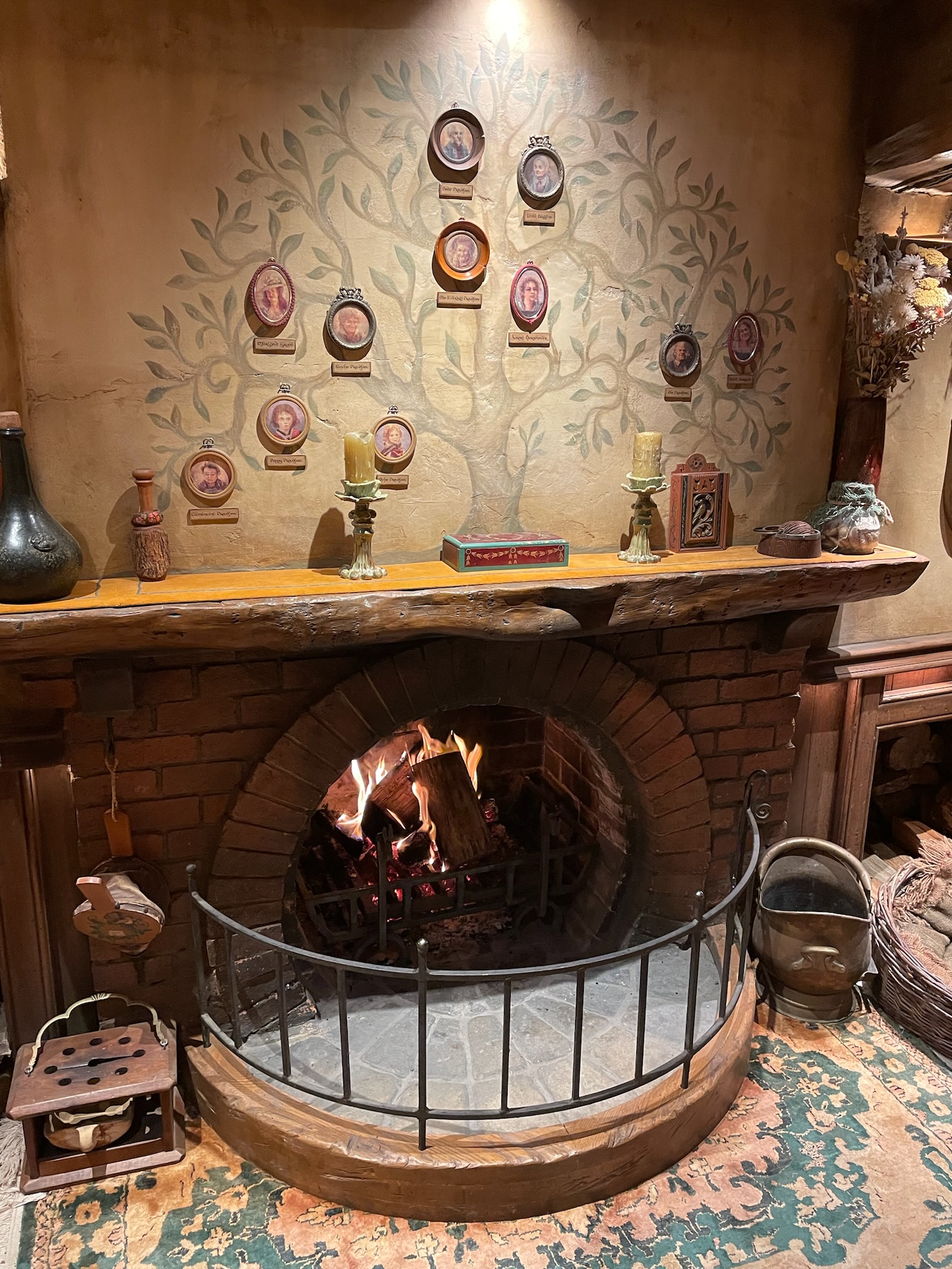 Inside a hobbit hole at Hobbiton, with a round fireplace and plates on the wall
