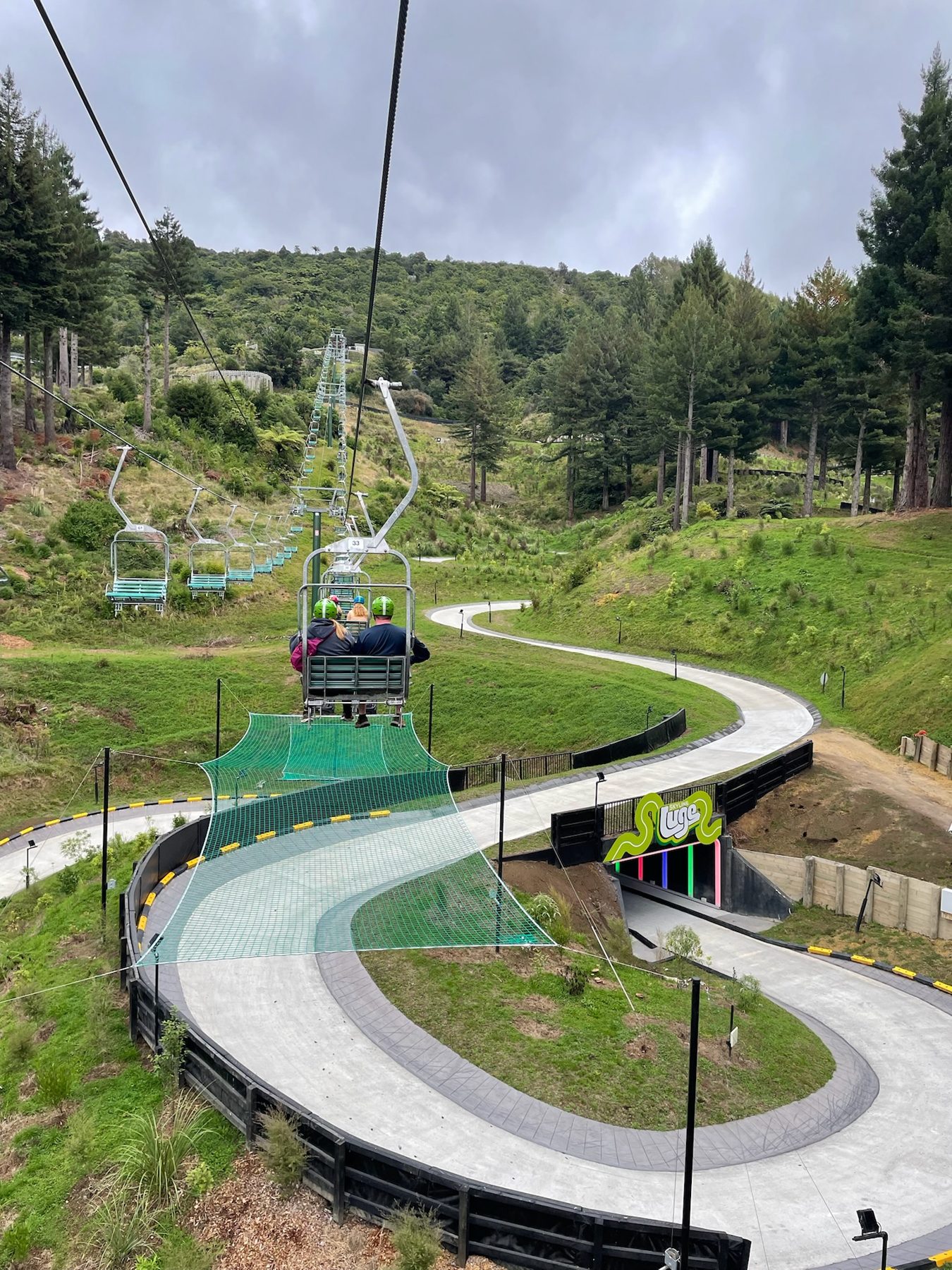 The Skyline Rotorua luge track winding downhill under the chairlift