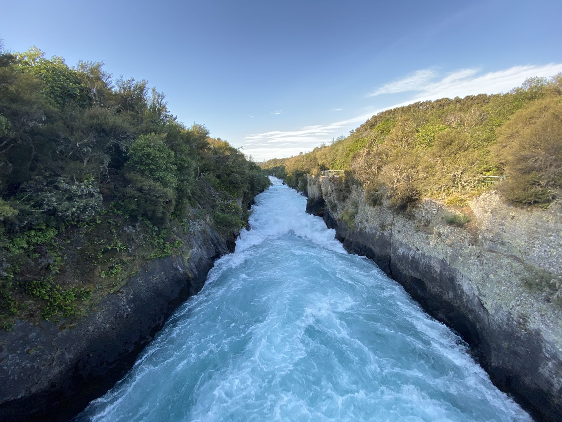The Waikato River squeezed through the rock chute, seen from the Huka Falls footbridge